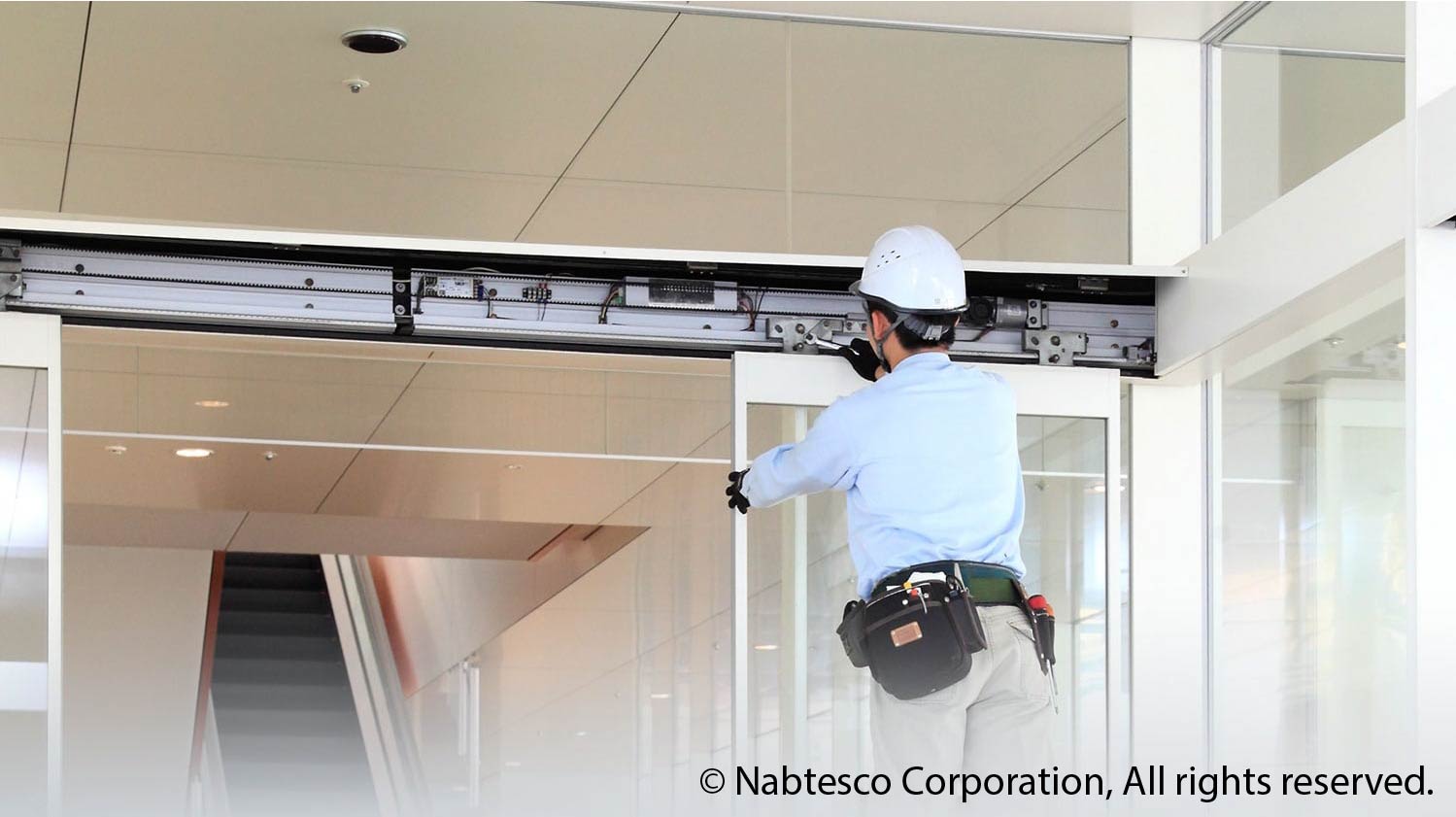 Technician installing Nabco automatic door-